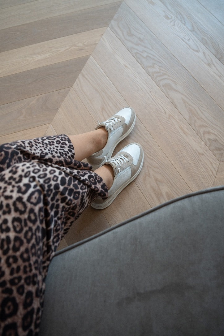 Silver ara sneakers on a herringbone wooden floor